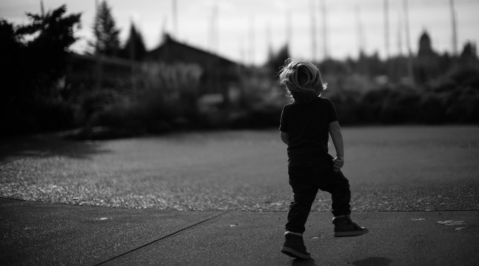 Black and white image of a young boy running.
